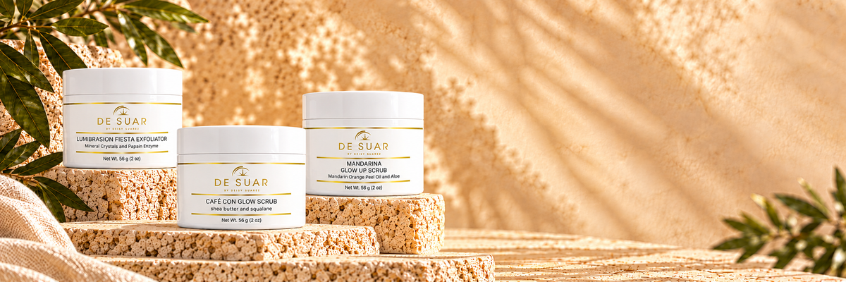 DE SUAR exfoliator jars on sunlit textured travertine stone